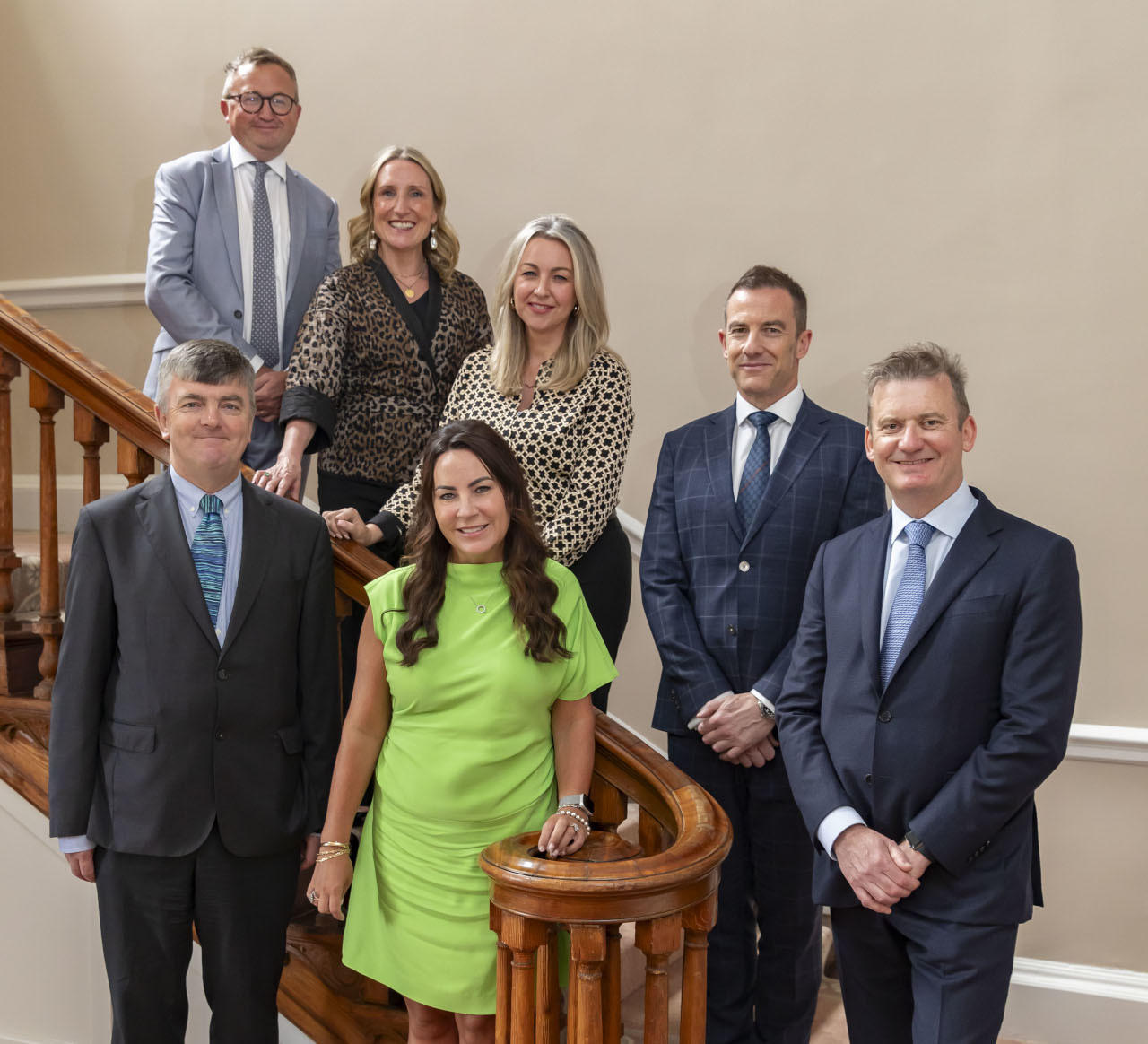Group of professional directors standing on a flight of stairs