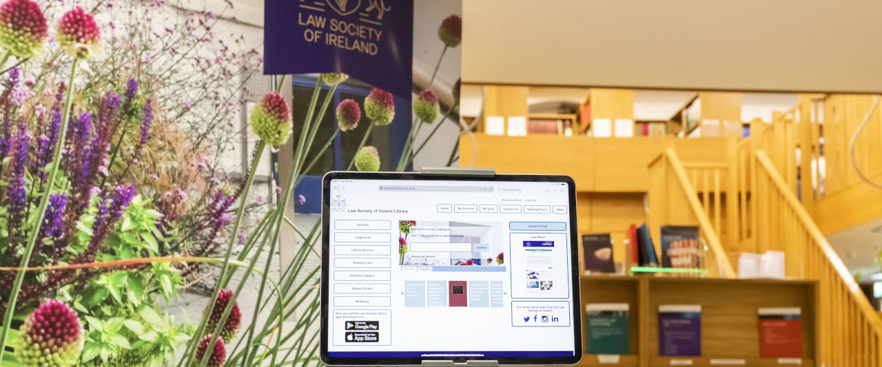 The entrance to the Law Society Library, with a pop-up banner and a tablet